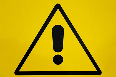 Alert icon in black on yellow background